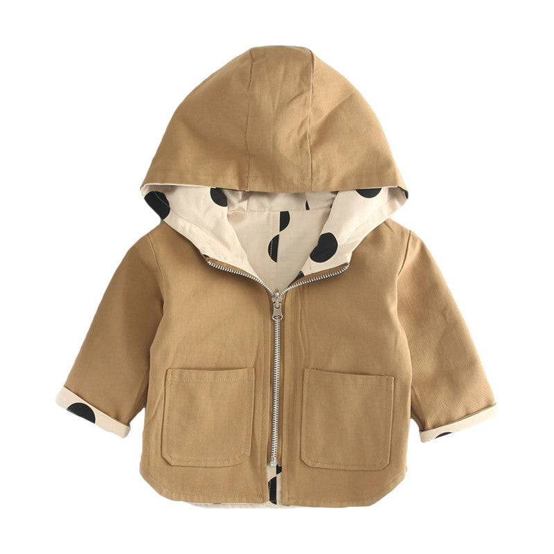 Kids' trench coat with playful black polka dot design, beige fabric, and a snug hood. Lightweight, stylish, and perfect for cooler seasons