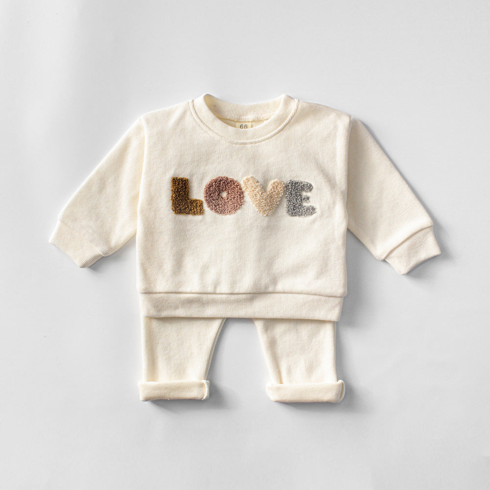 Baby Lovey Set with long-sleeve top featuring embroidered detail and comfy matching pants. Available in two colors, made from soft, breathable fabric for everyday comfort