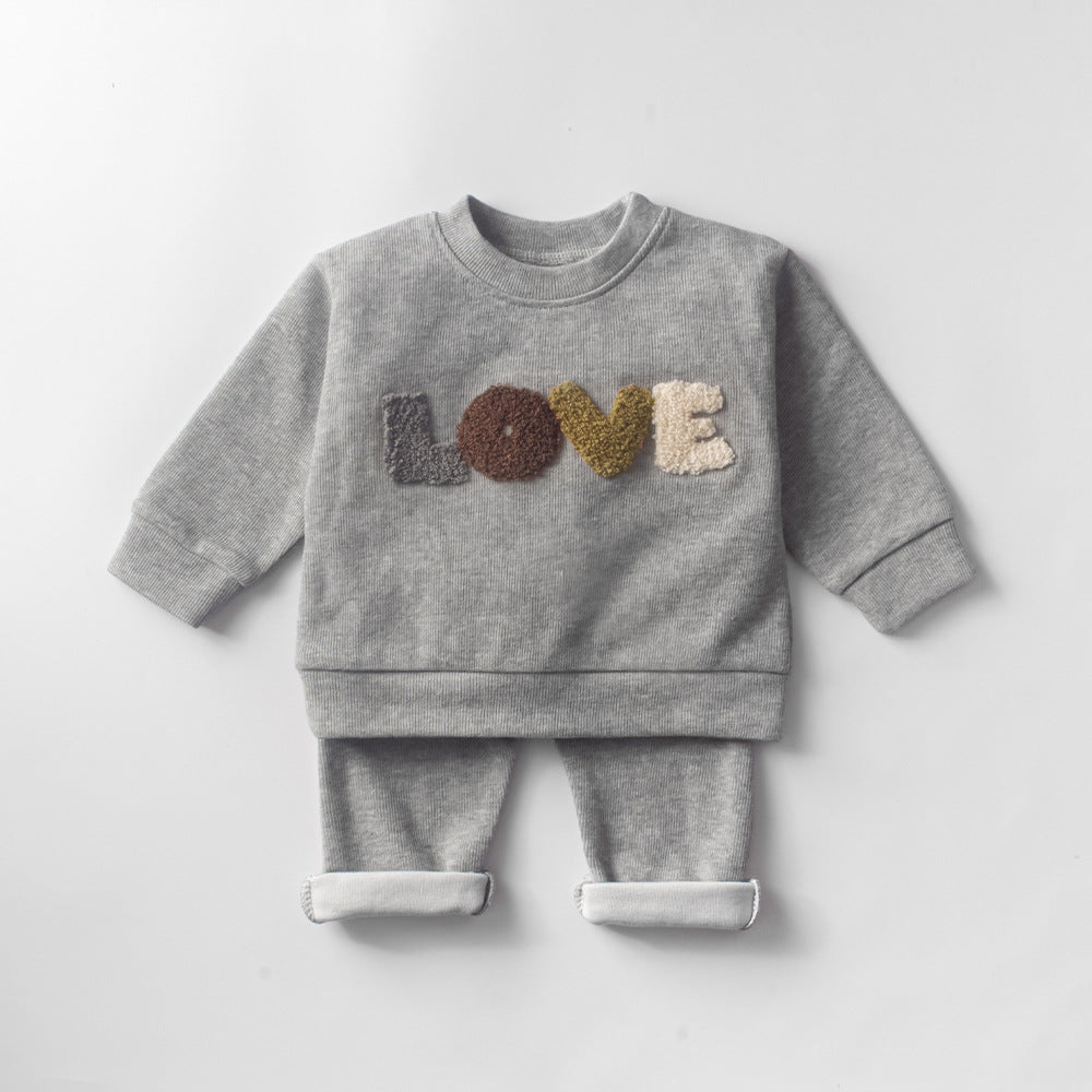 Baby Lovey Set with long-sleeve top featuring embroidered detail and comfy matching pants. Available in two colors, made from soft, breathable fabric for everyday comfort