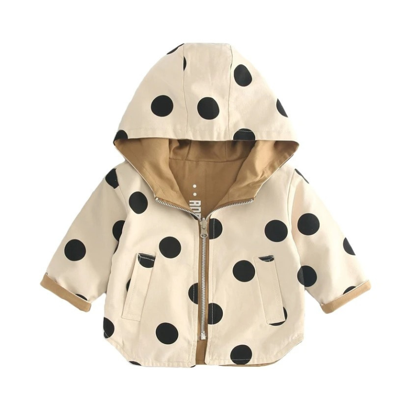 Kids' trench coat with playful black polka dot design, beige fabric, and a snug hood. Lightweight, stylish, and perfect for cooler seasons