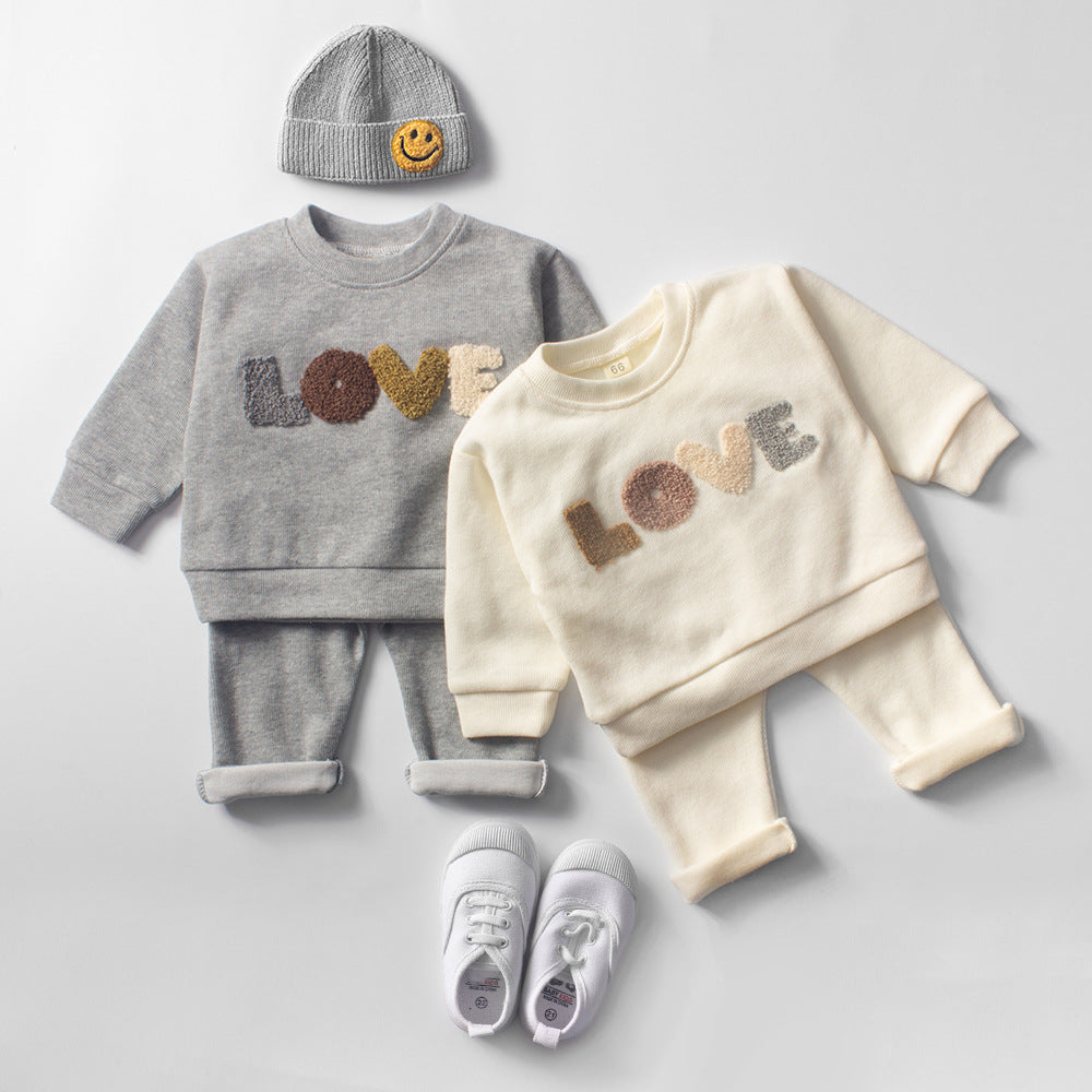 Baby Lovey Set with long-sleeve top featuring embroidered detail and comfy matching pants. Available in two colors, made from soft, breathable fabric for everyday comfort