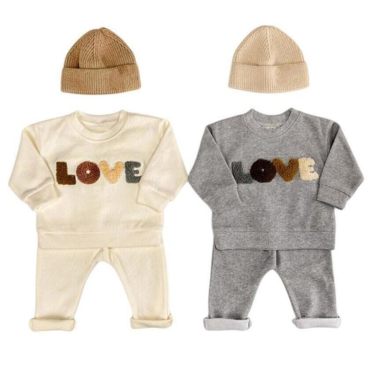 Baby Lovey Set with long-sleeve top featuring embroidered detail and comfy matching pants. Available in two colors, made from soft, breathable fabric for everyday comfort