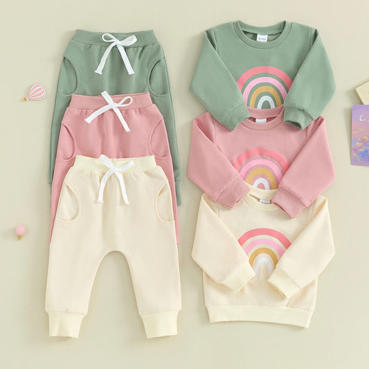 Baby Rainbow Set featuring a long-sleeve top with a cheerful rainbow design and comfy pants with an adjustable drawstring. Available in vibrant colors for everyday adventures.